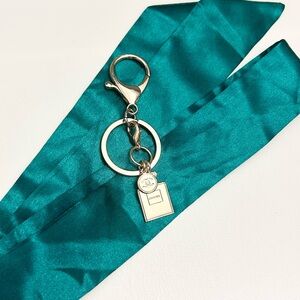 Chanel beauty charm - attached keychain / bag charm + dark green satin Twilly